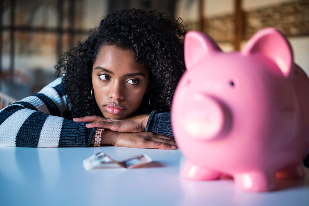 Sad,Thoughtful,Frustrated,Black,Woman,With,Piggy,Bank
