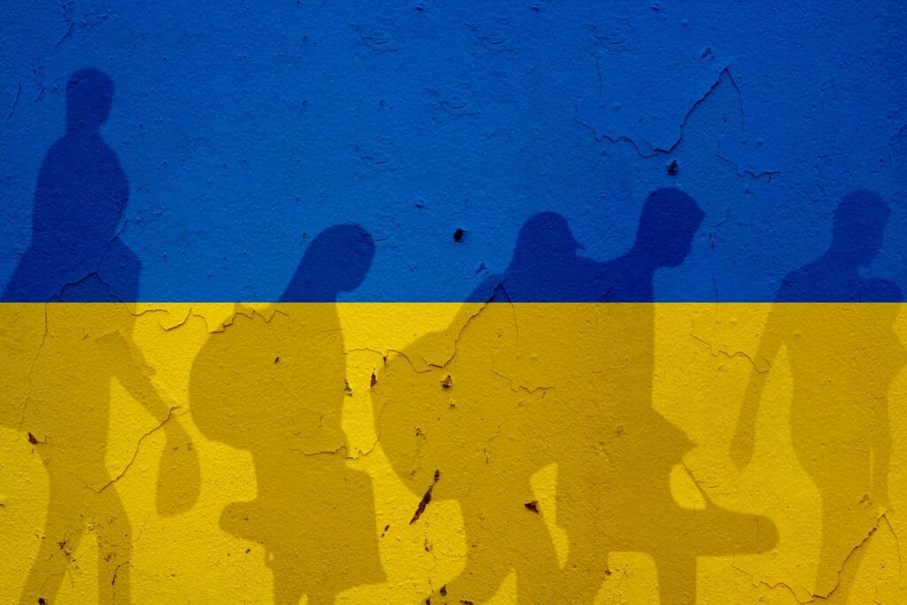Ukraine,Flag,On,Wall,And,Refugee,Shadows.,Ukraine,War,Concept.