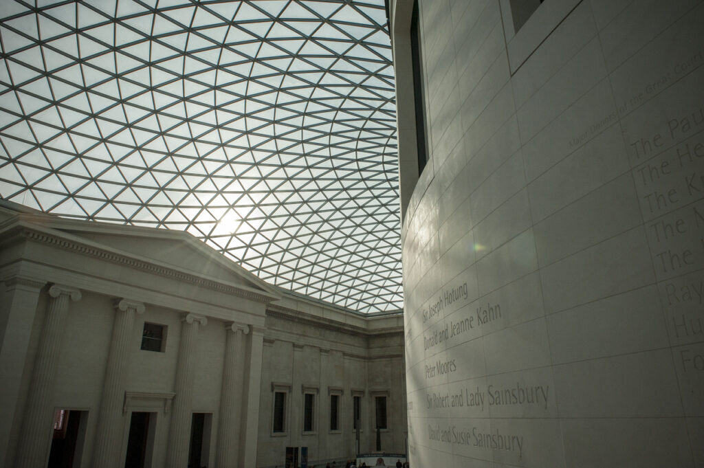 London, UK - January 31, 2009: Sun shines through glass ceiling of British Museum London, reflected on the marble wall. London, England
