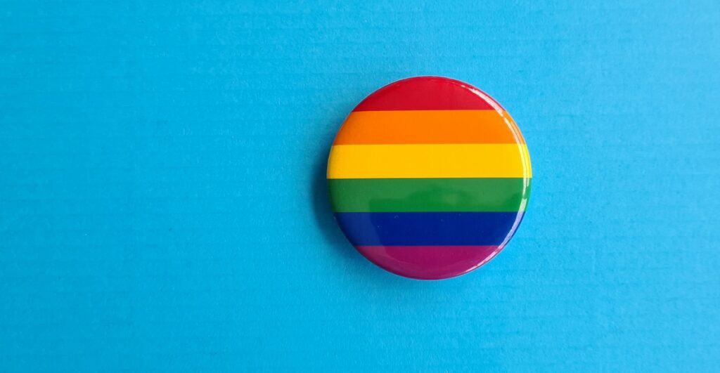 LGBT icon in shape of a circle on rainbow flag. Sexual minorities